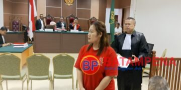 Terdakwa Nurmian Manalu meninggalkan ruang persidangan di PN Batam didampingi oleh penasehat hukumnya, Niko Nixon Situmorang. (Sumber foto: JP - BatamPena.com)