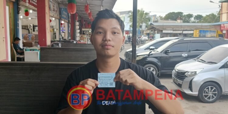 Mahasiswa Fakultas Hukum Universitas Internasional Batam (UIB) atas nama Risky Kurniawan menunjukkan karcis parkir palsu. (Sumber foto: JP - BatamPena.com)